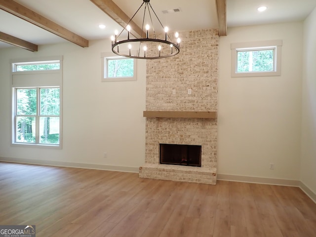 45 Hometown Ct, Jefferson, GA 30549 - unfurnished living room featuring a notable chandelier, beam ceiling, visible vents, and hardwood / wood-style floors