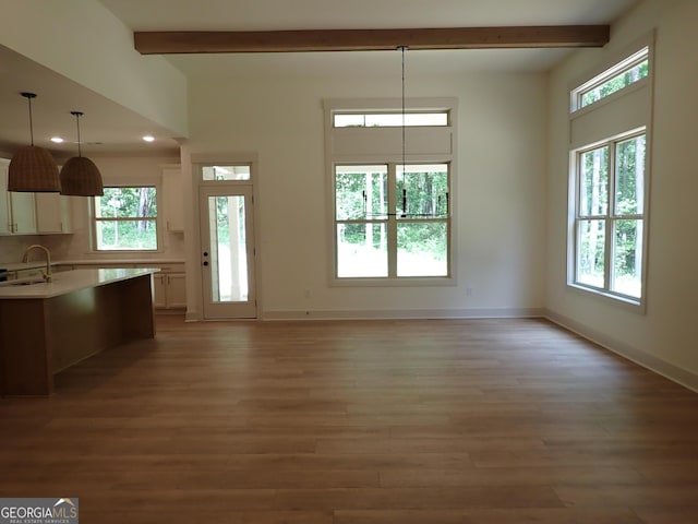 45 Hometown Ct, Jefferson, GA 30549 - unfurnished dining area featuring a healthy amount of sunlight, a sink, and beam ceiling