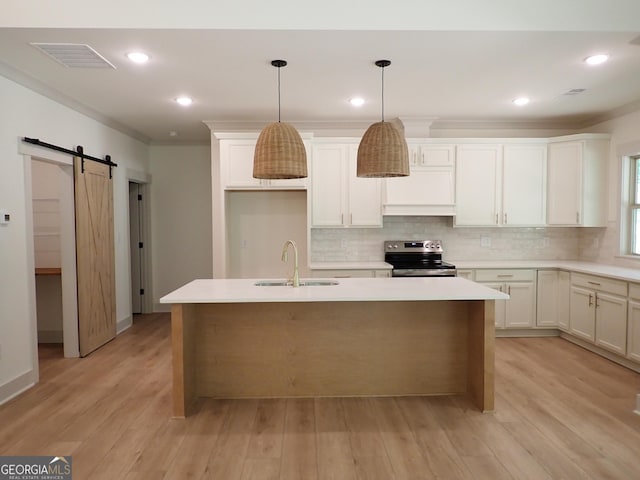 45 Hometown Ct, Jefferson, GA 30549 - kitchen with a sink, a barn door, stainless steel electric range, visible vents, and decorative backsplash