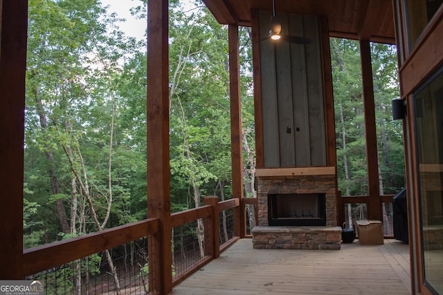 unfurnished sunroom featuring a wooded view
