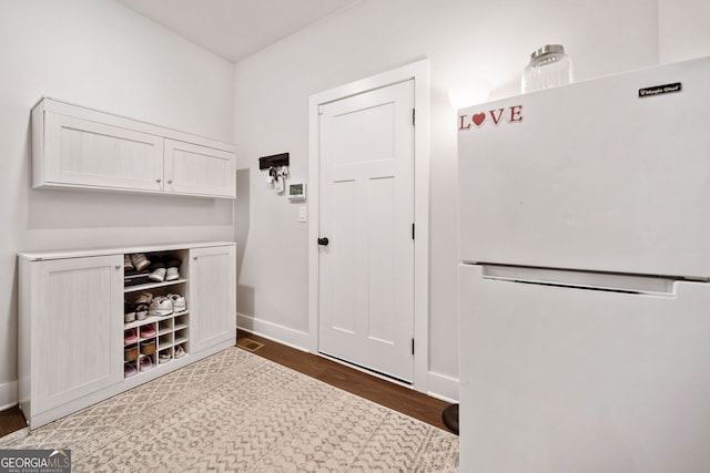 interior space featuring baseboards and wood finished floors
