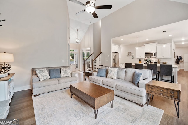 living area with wood finished floors, high vaulted ceiling, recessed lighting, and ceiling fan