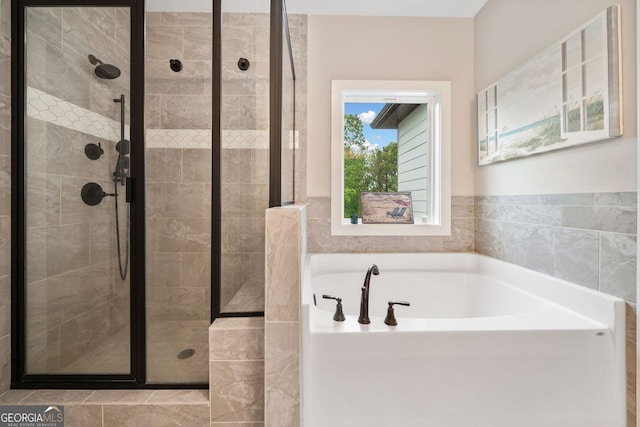 bathroom with a garden tub and a shower stall