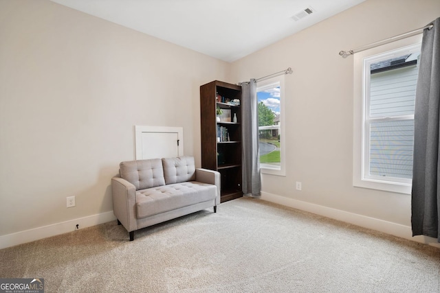 sitting room featuring baseboards, visible vents, and carpet
