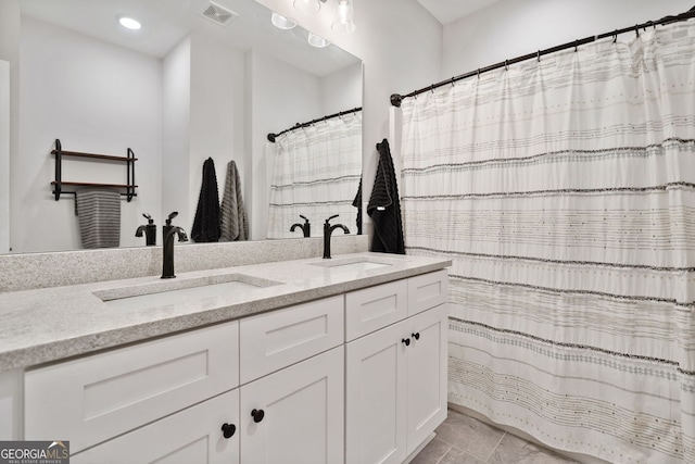 bathroom featuring double vanity, visible vents, marble finish floor, and a sink