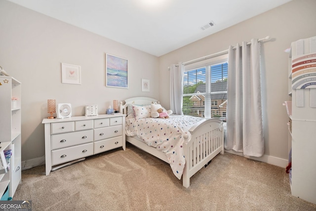bedroom featuring light carpet, visible vents, and baseboards