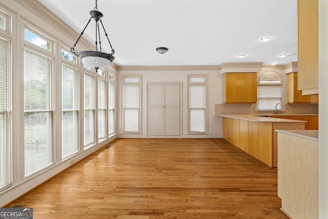 5510 Conway Dr, Marietta, GA 30068 - kitchen with light wood finished floors, light brown cabinets, light countertops, ornamental molding, and pendant lighting