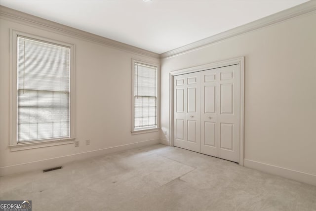 5510 Conway Dr, Marietta, GA 30068 - unfurnished bedroom with visible vents, crown molding, baseboards, a closet, and light carpet