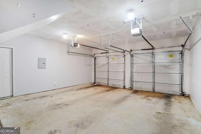garage with electric panel and a garage door opener