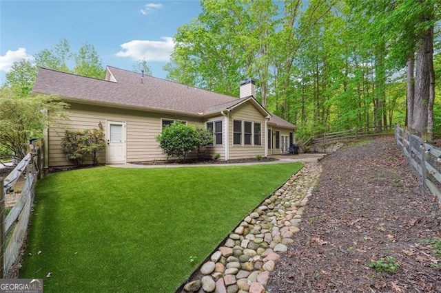 7045 Mountain Xing, Cumming, GA 30041 - back of property with a chimney, a yard, an attached garage, a patio area, and french doors