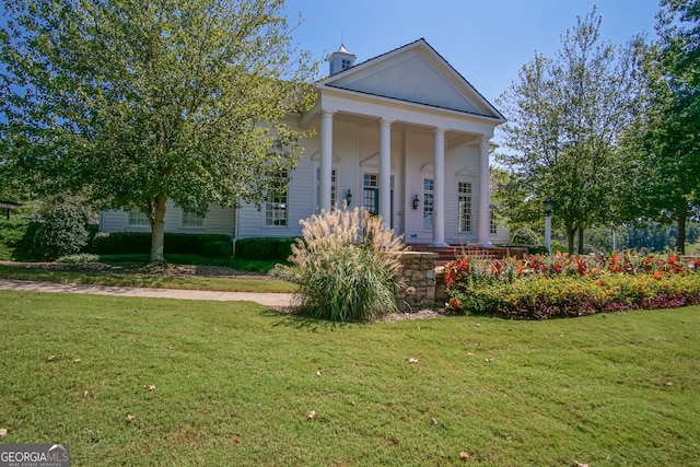 7045 Mountain Xing, Cumming, GA 30041 - neoclassical home featuring a front yard and covered porch