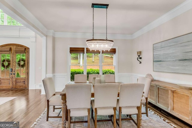 1400 Squire Ln, Cumming, GA 30041 - dining space featuring a notable chandelier, a wainscoted wall, light wood-type flooring, and plenty of natural light