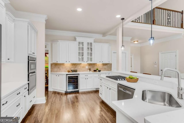 1400 Squire Ln, Cumming, GA 30041 - kitchen with white cabinets, light countertops, a sink, and wine cooler