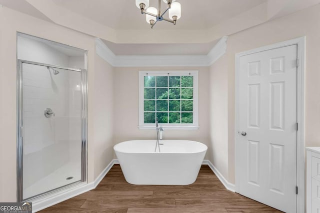 1400 Squire Ln, Cumming, GA 30041 - full bath featuring a stall shower, baseboards, a notable chandelier, a freestanding tub, and wood finished floors