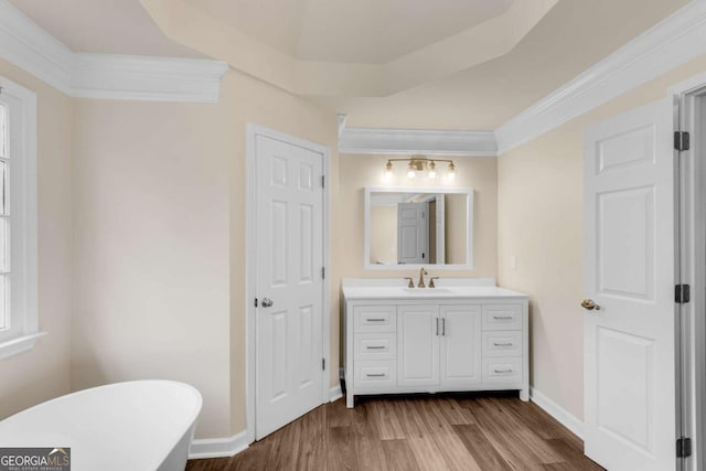 1400 Squire Ln, Cumming, GA 30041 - full bath with wood finished floors, vanity, a freestanding bath, baseboards, and ornamental molding