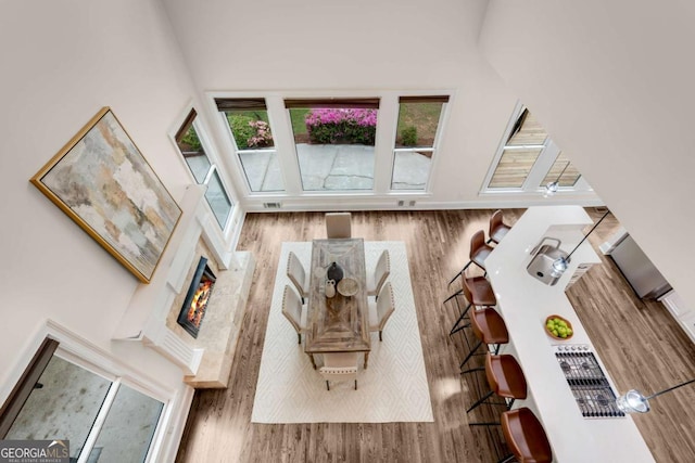 1400 Squire Ln, Cumming, GA 30041 - living room featuring a fireplace, wood finished floors, and a towering ceiling