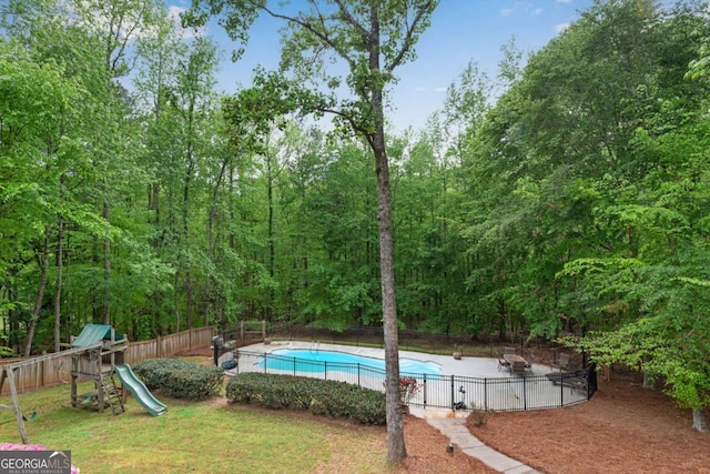 1400 Squire Ln, Cumming, GA 30041 - view of swimming pool with a fenced backyard, a fenced in pool, a playground, and a lawn