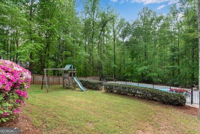 1400 Squire Ln, Cumming, GA 30041 - view of yard with a fenced in pool, a playground, and fence