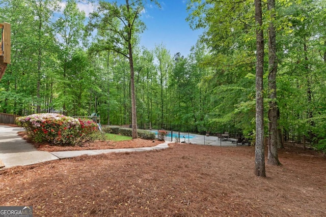 1400 Squire Ln, Cumming, GA 30041 - view of yard with fence, an outdoor pool, and a wooded view