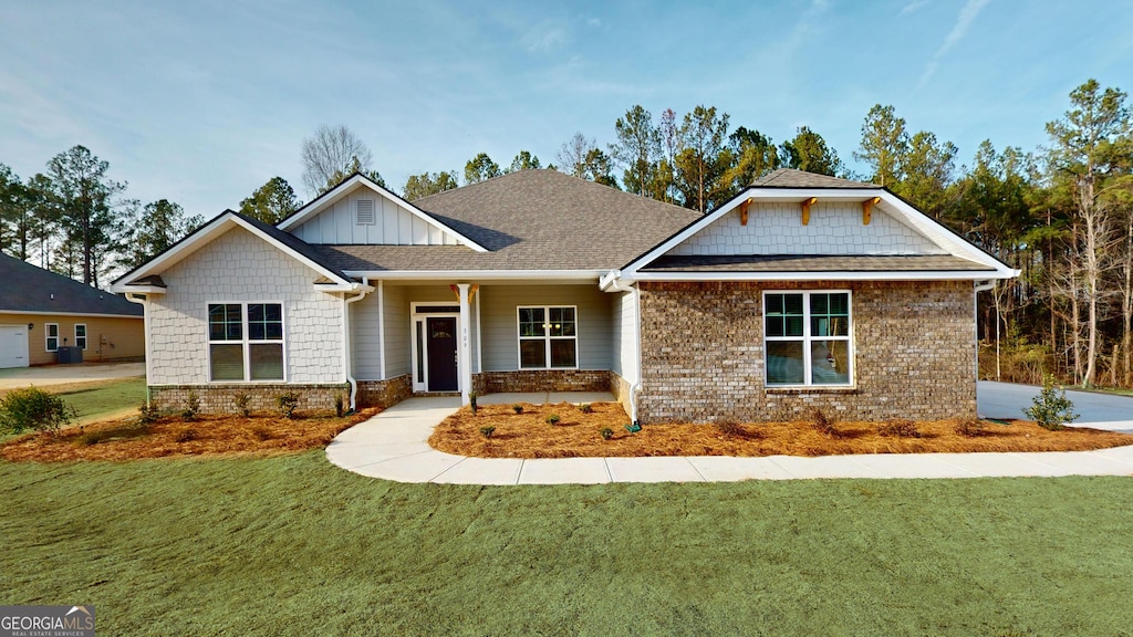117 Abberley Ln, Macon, GA 31216 - craftsman-style home with a front yard, brick siding, board and batten siding, and a shingled roof