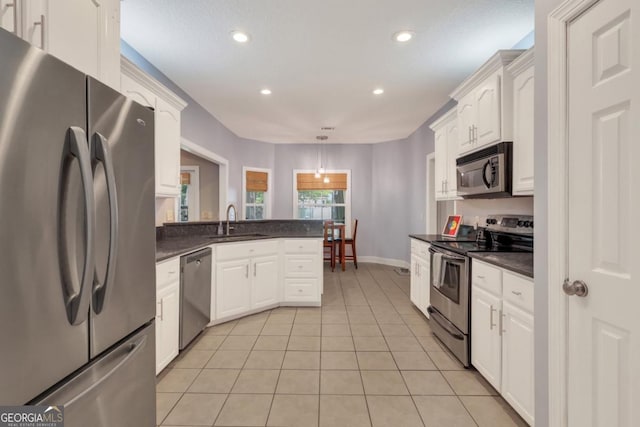 277 Cinder Hill Dr, Brunswick, GA 31523 - kitchen with dark countertops, appliances with stainless steel finishes, and white cabinetry
