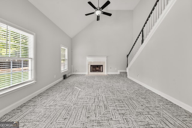 990 Lilac Arbor Rd, Dacula, GA 30019 - unfurnished living room featuring ceiling fan, high vaulted ceiling, stairway, carpet flooring, and a premium fireplace