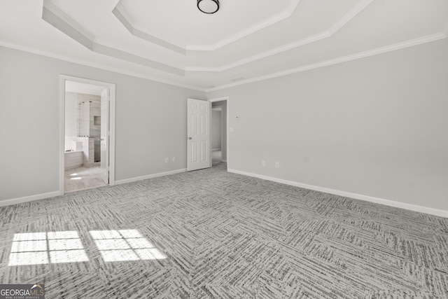 990 Lilac Arbor Rd, Dacula, GA 30019 - unfurnished bedroom with crown molding, baseboards, a raised ceiling, connected bathroom, and carpet flooring