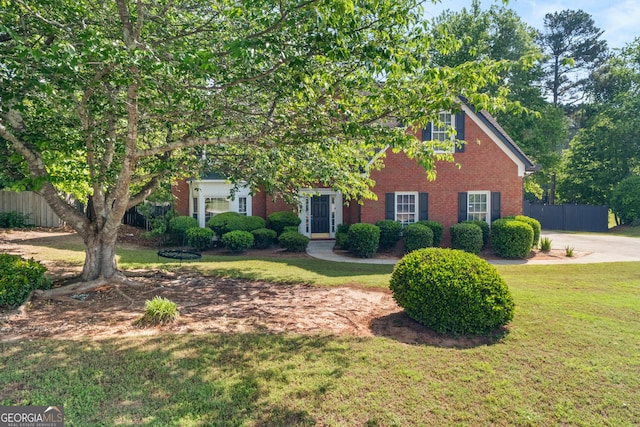 990 Lilac Arbor Rd, Dacula, GA 30019 - obstructed view of property featuring brick siding, a front lawn, and fence