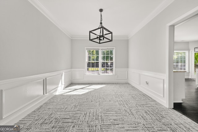 990 Lilac Arbor Rd, Dacula, GA 30019 - unfurnished dining area featuring an inviting chandelier, carpet, crown molding, and a wainscoted wall