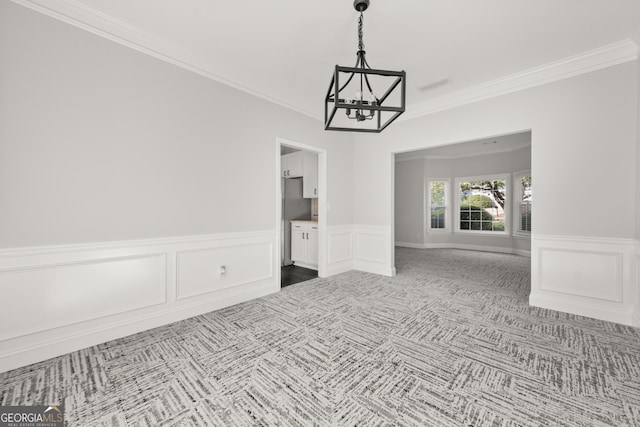 990 Lilac Arbor Rd, Dacula, GA 30019 - spare room featuring carpet floors, a notable chandelier, ornamental molding, and a wainscoted wall