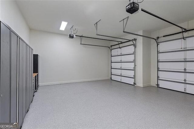 garage with baseboards and a garage door opener