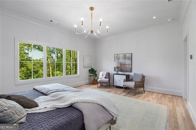 bedroom featuring light wood finished floors, baseboards, visible vents, a chandelier, and ornamental molding
