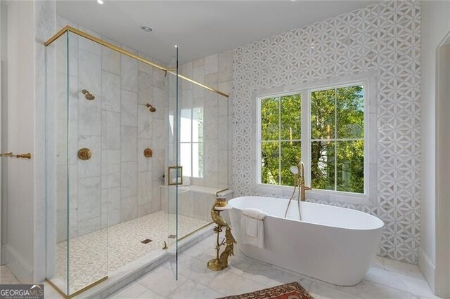 full bathroom featuring tile patterned floors, a freestanding tub, and a stall shower