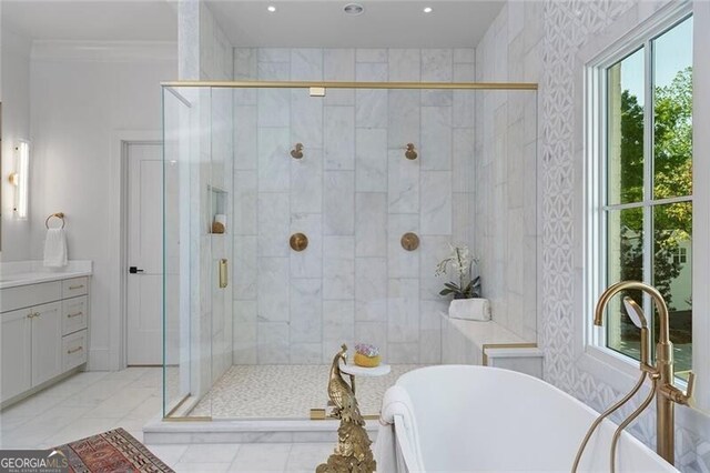 bathroom with a soaking tub, vanity, crown molding, and a stall shower