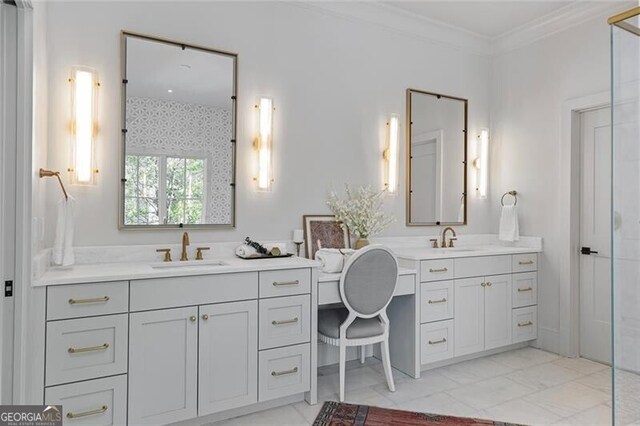 full bathroom with two vanities, marble finish floor, ornamental molding, and a sink