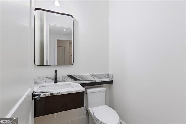 bathroom featuring vanity and toilet