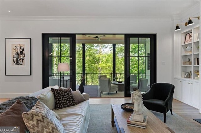 living area featuring ceiling fan, a healthy amount of sunlight, and ornamental molding