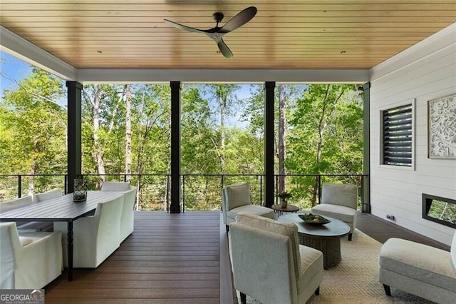 sunroom with outdoor dining space and ceiling fan