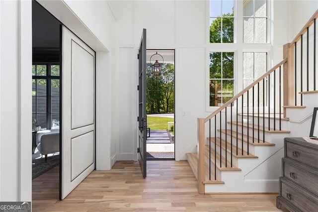entryway with stairway and light wood-style floors