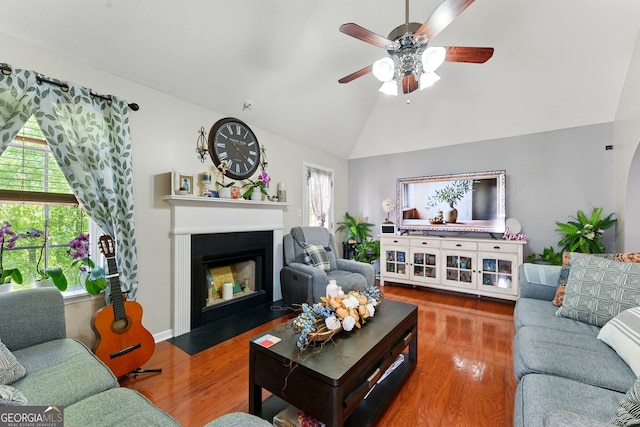 1010 Augusta Woods Dr, Douglasville, GA 30134 - living room featuring a fireplace with flush hearth, a ceiling fan, wood finished floors, and a healthy amount of sunlight