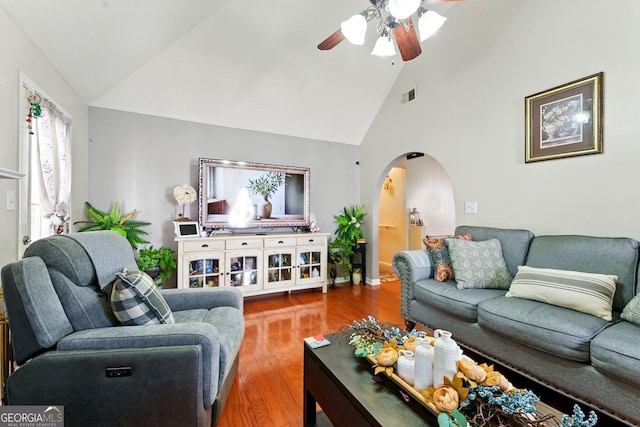 1010 Augusta Woods Dr, Douglasville, GA 30134 - living room featuring arched walkways, visible vents, wood finished floors, ceiling fan, and high vaulted ceiling