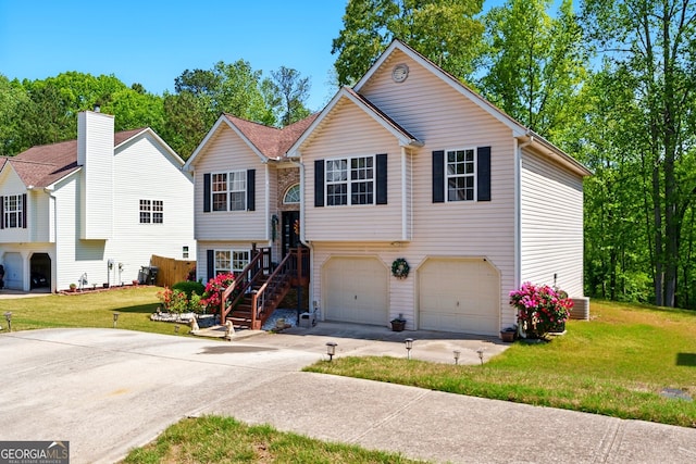 1010 Augusta Woods Dr, Douglasville, GA 30134 - bi-level home featuring a garage, driveway, and a front lawn