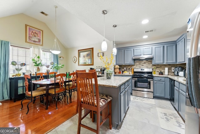 1010 Augusta Woods Dr, Douglasville, GA 30134 - kitchen featuring gray cabinets, appliances with stainless steel finishes, visible vents, and a kitchen island