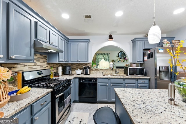 1010 Augusta Woods Dr, Douglasville, GA 30134 - kitchen with under cabinet range hood, backsplash, blue cabinets, a sink, and appliances with stainless steel finishes