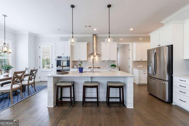 4405 Croftshire Pl, Cumming, GA 30040 - kitchen with stainless steel appliances, wall chimney range hood, a breakfast bar, dark wood-style flooring, and recessed lighting
