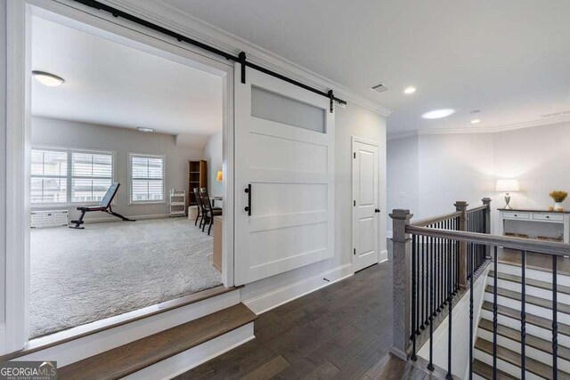 4405 Croftshire Pl, Cumming, GA 30040 - hallway with ornamental molding, a barn door, wood finished floors, recessed lighting, and baseboards