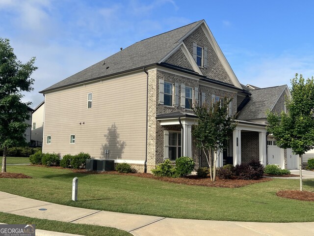4405 Croftshire Pl, Cumming, GA 30040 - view of side of home featuring brick siding, a lawn, and a shingled roof