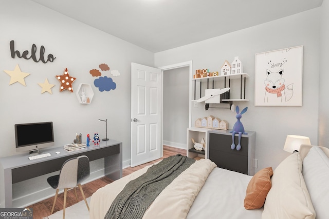 bedroom with baseboards and wood finished floors