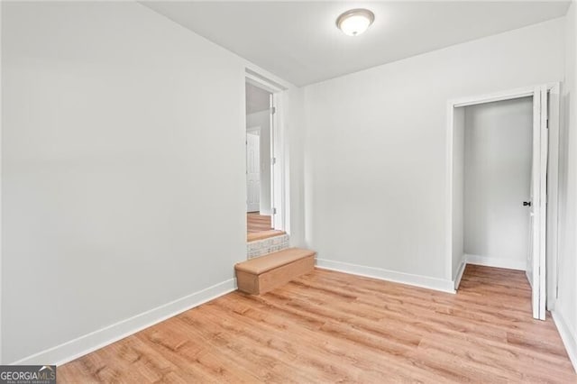 unfurnished bedroom featuring baseboards and light wood-style floors