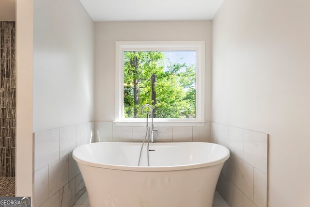 1541 Pontiac Pl SE, Atlanta, GA 30315 - full bathroom featuring tile walls, a freestanding tub, and wainscoting